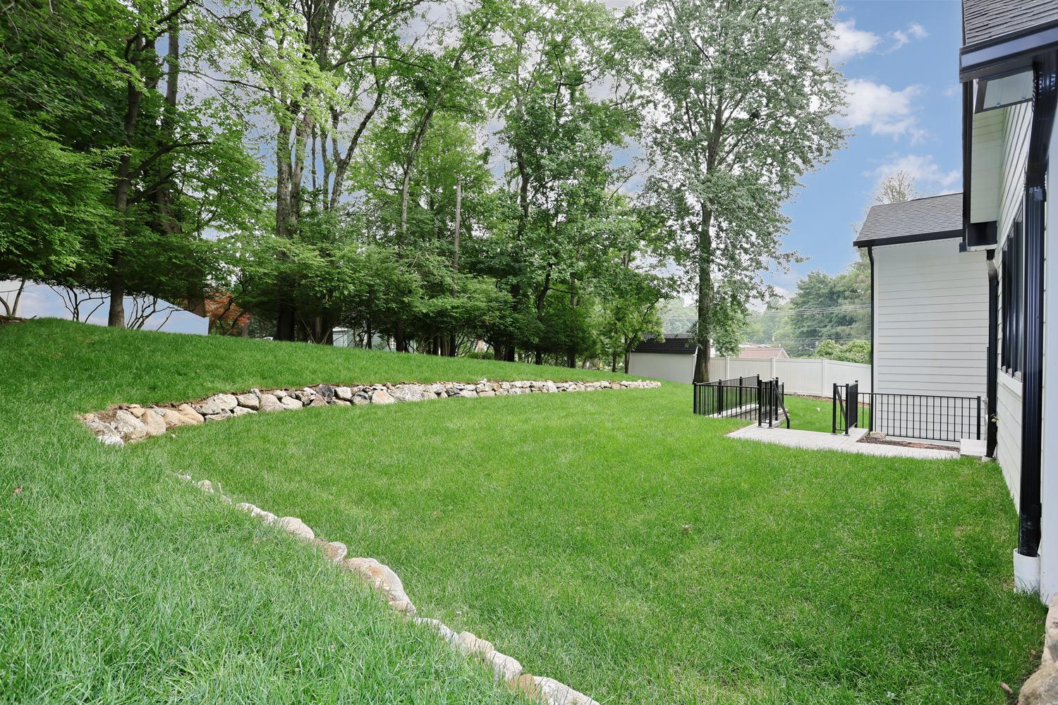 Hillsdale NJ custom home — Backyard — Level Lawn — Dadak LLC