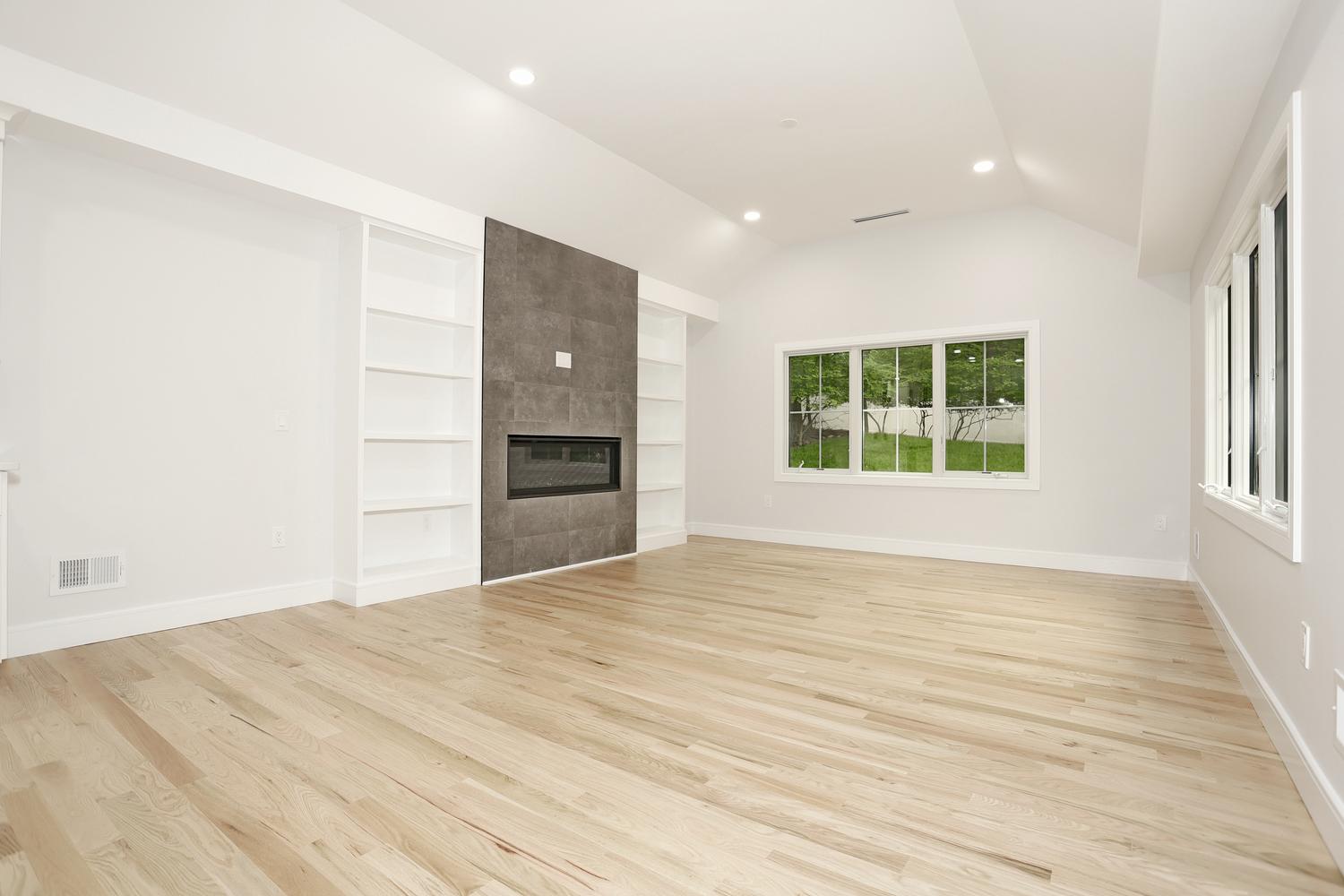Family room with linear fireplace and custom built-ins in Hillsdale NJ by Dadak LLC
