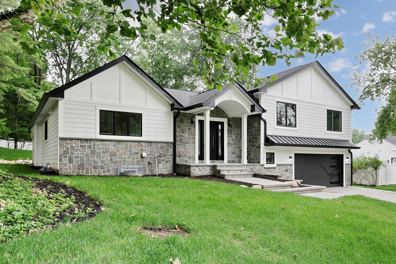 New custom home in Hillsdale NJ with stone and board-and-batten facade built by Dadak LLC