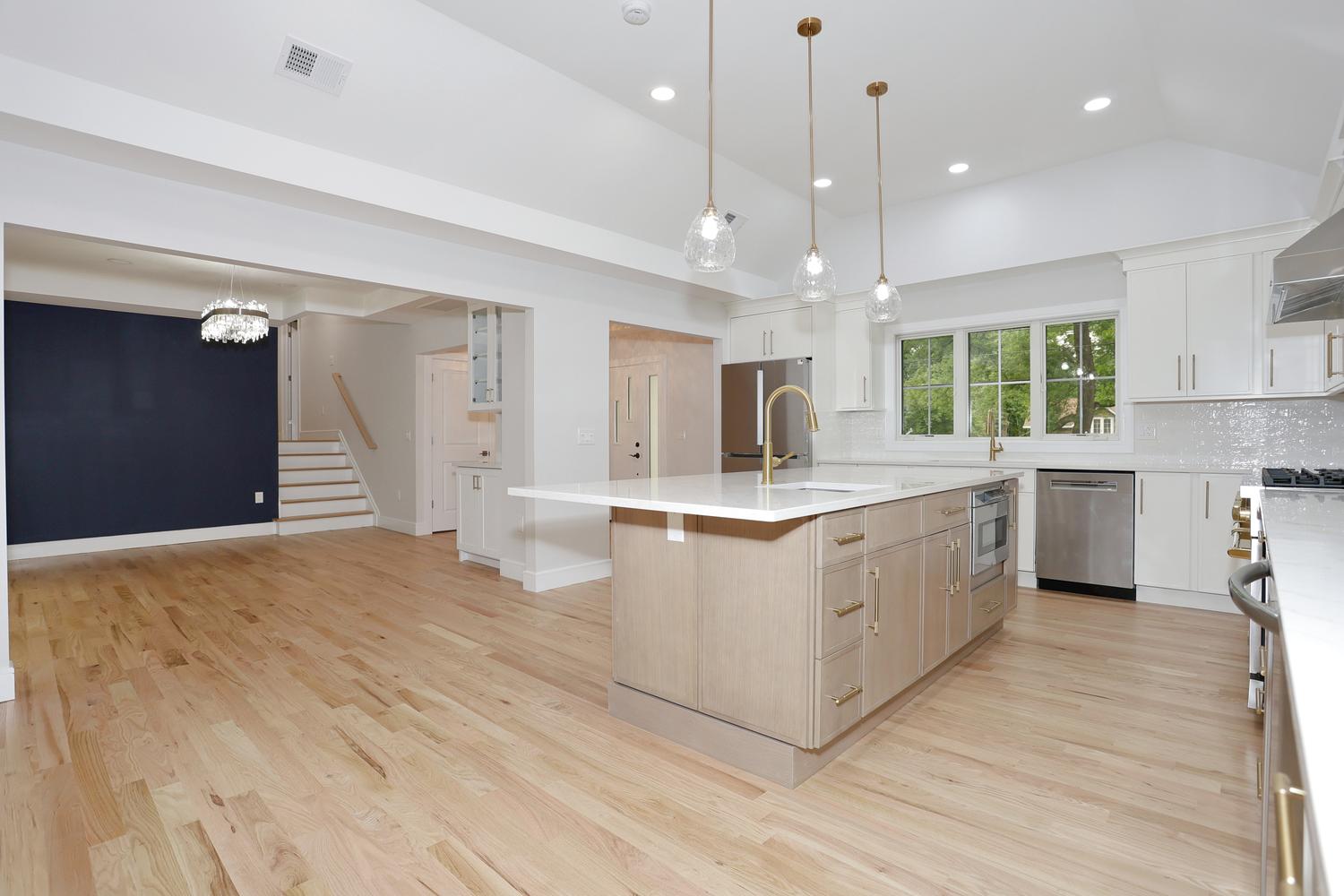 Custom kitchen with marble waterfall island and gold fixtures in Hillsdale NJ by Dadak LLC