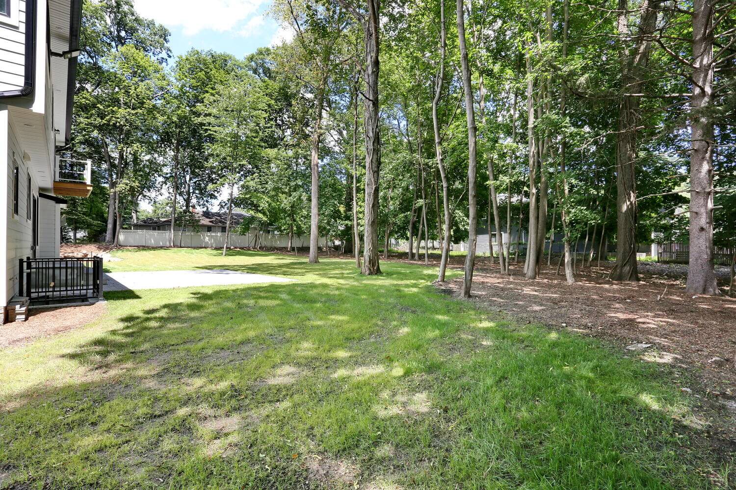 Montvale outdoor — Backyard Wooded Lot Green Lawn — Dadak LLC