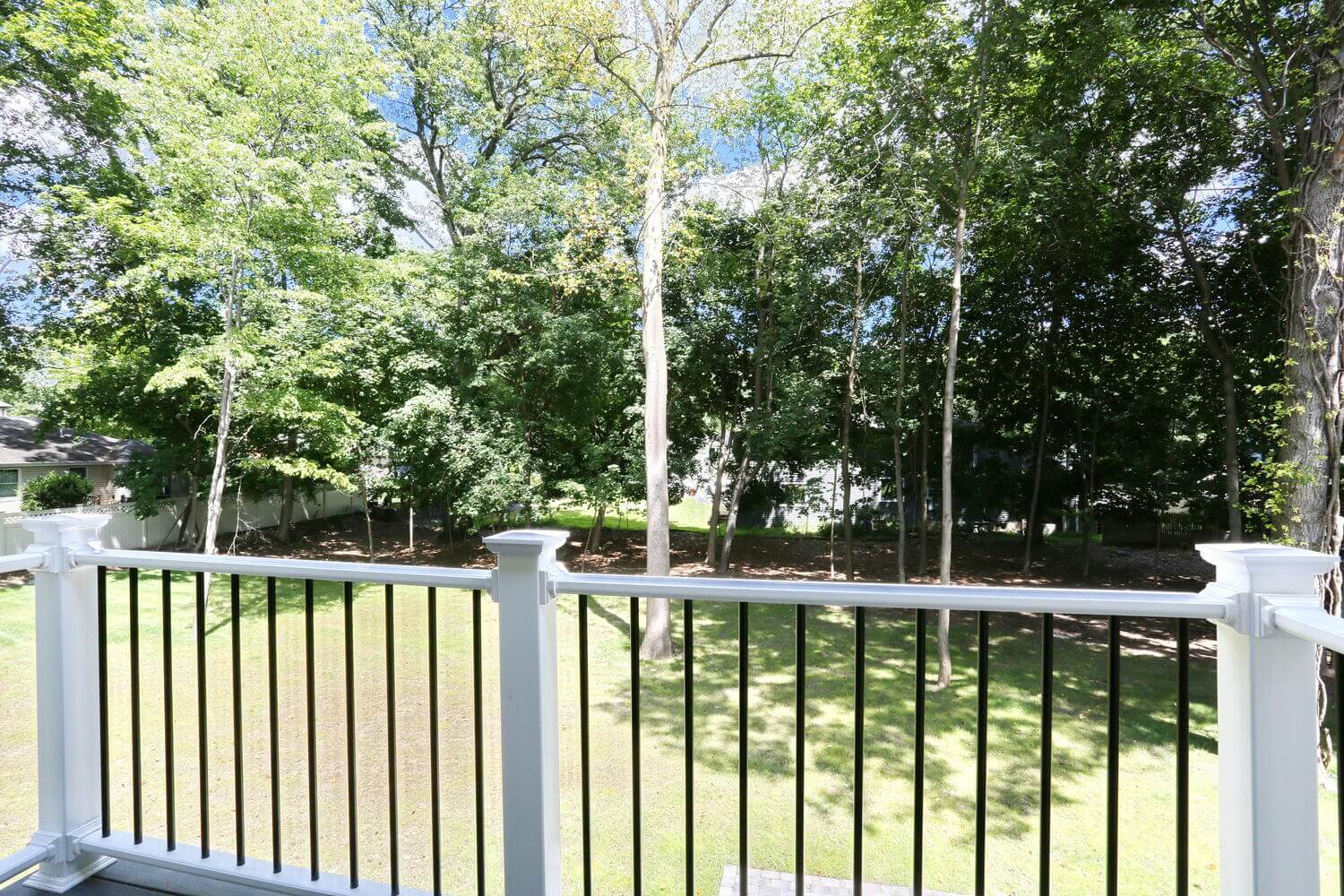 Second-story balcony addition overlooking backyard, built by Dadak LLC in Montvale, NJ