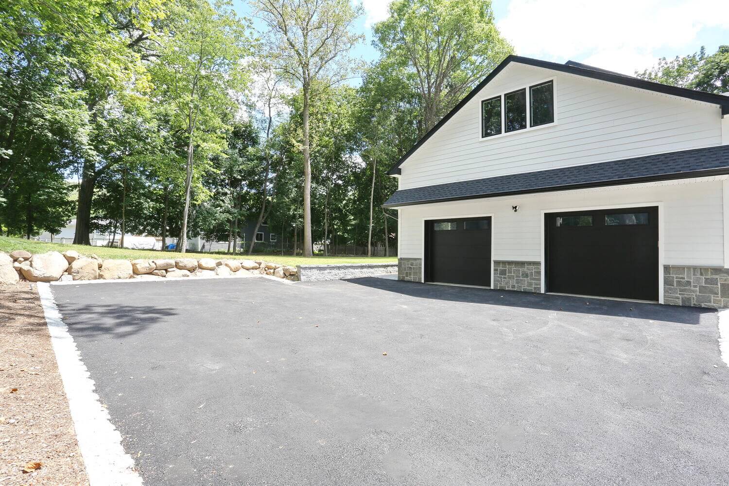 Montvale exterior — Custom Home Black Garage Doors — Dadak LLC