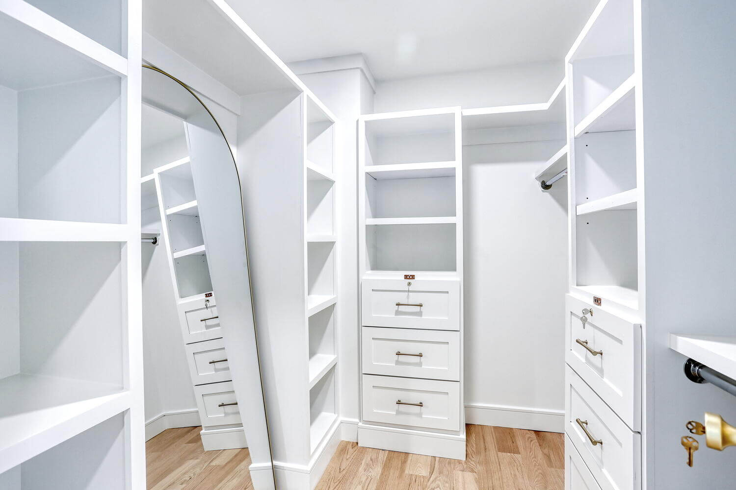 Montvale primary suite — Primary Closet White Cabinetry Mirror — Dadak LLC