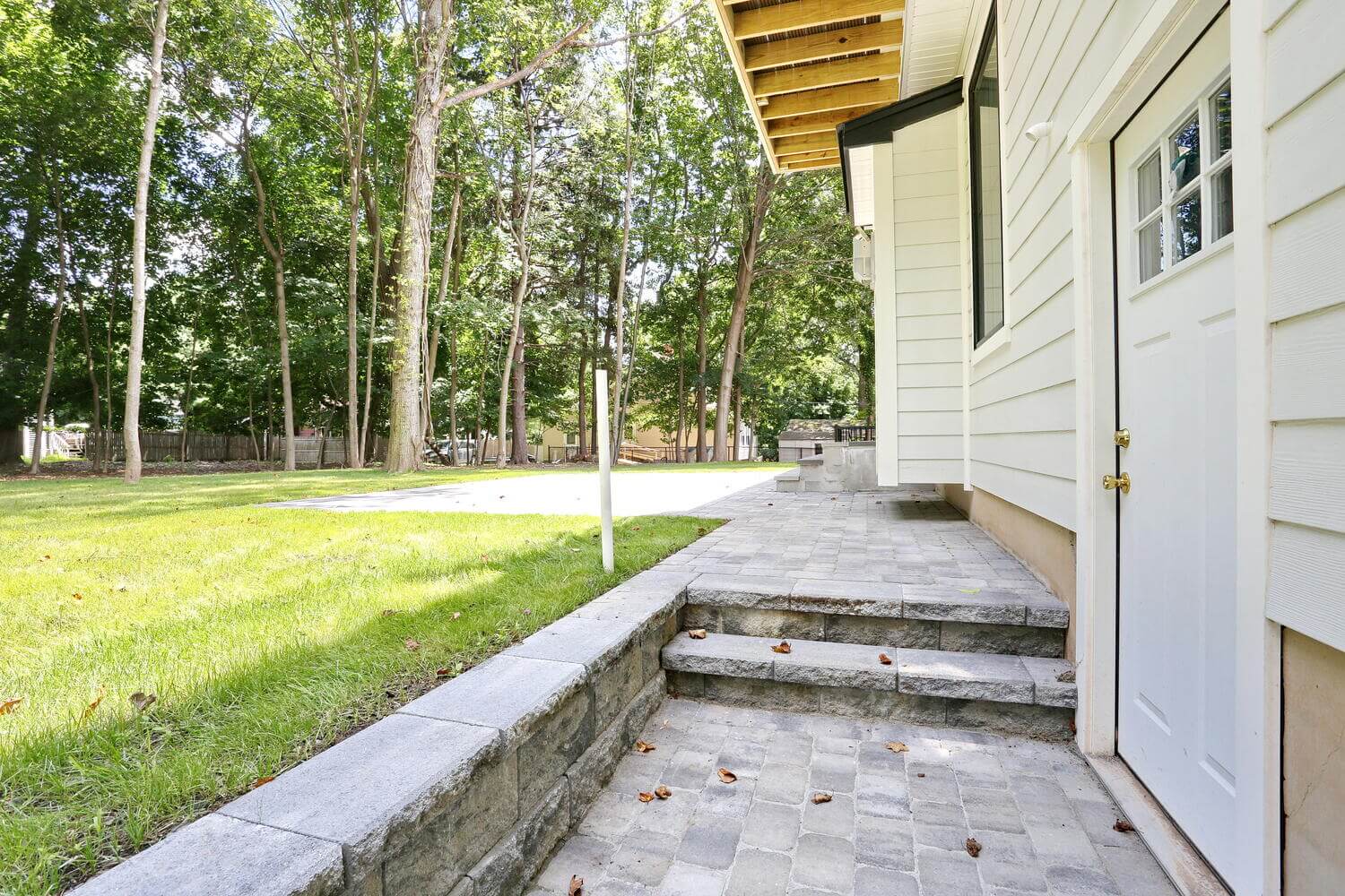 Montvale exterior — Side Entrance Stone Walkway — Dadak LLC