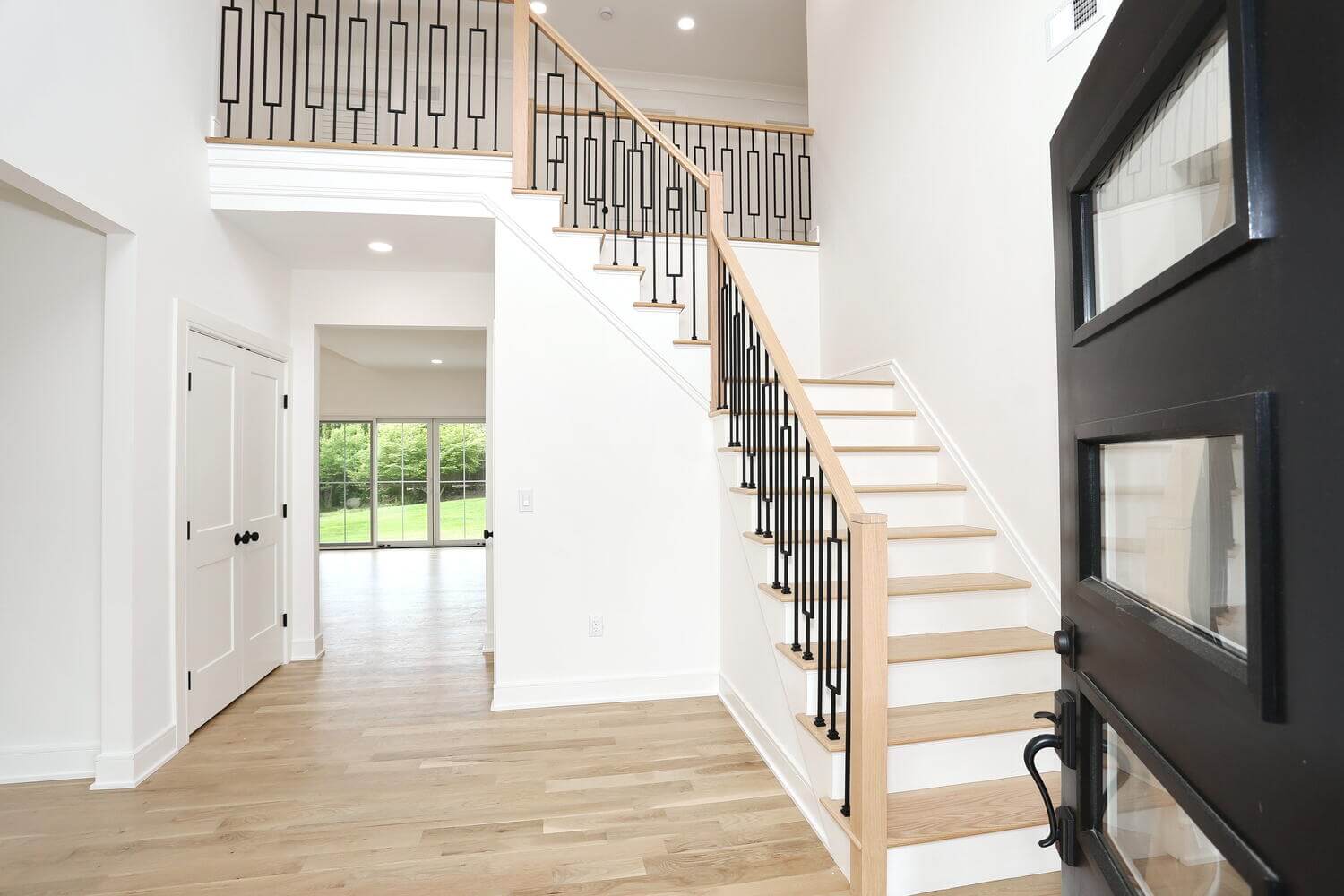 Park Ridge entryway & stairs — Foyer Staircase — Dadak LLC