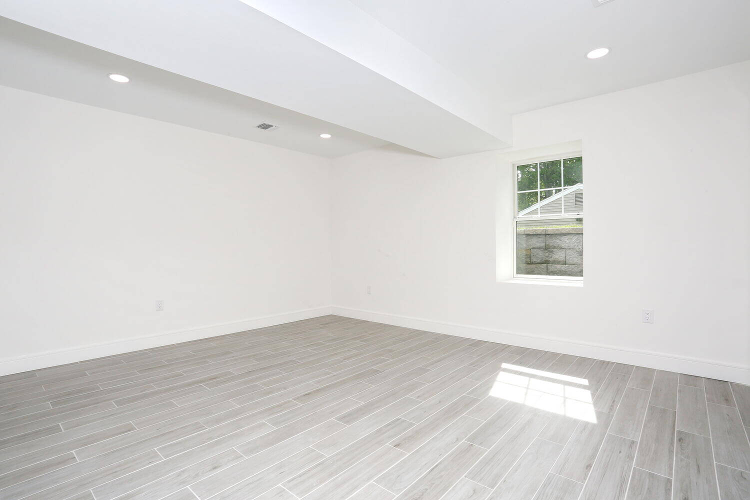 Park Ridge basement — Lower Level Bedroom Five Window View — Dadak LLC