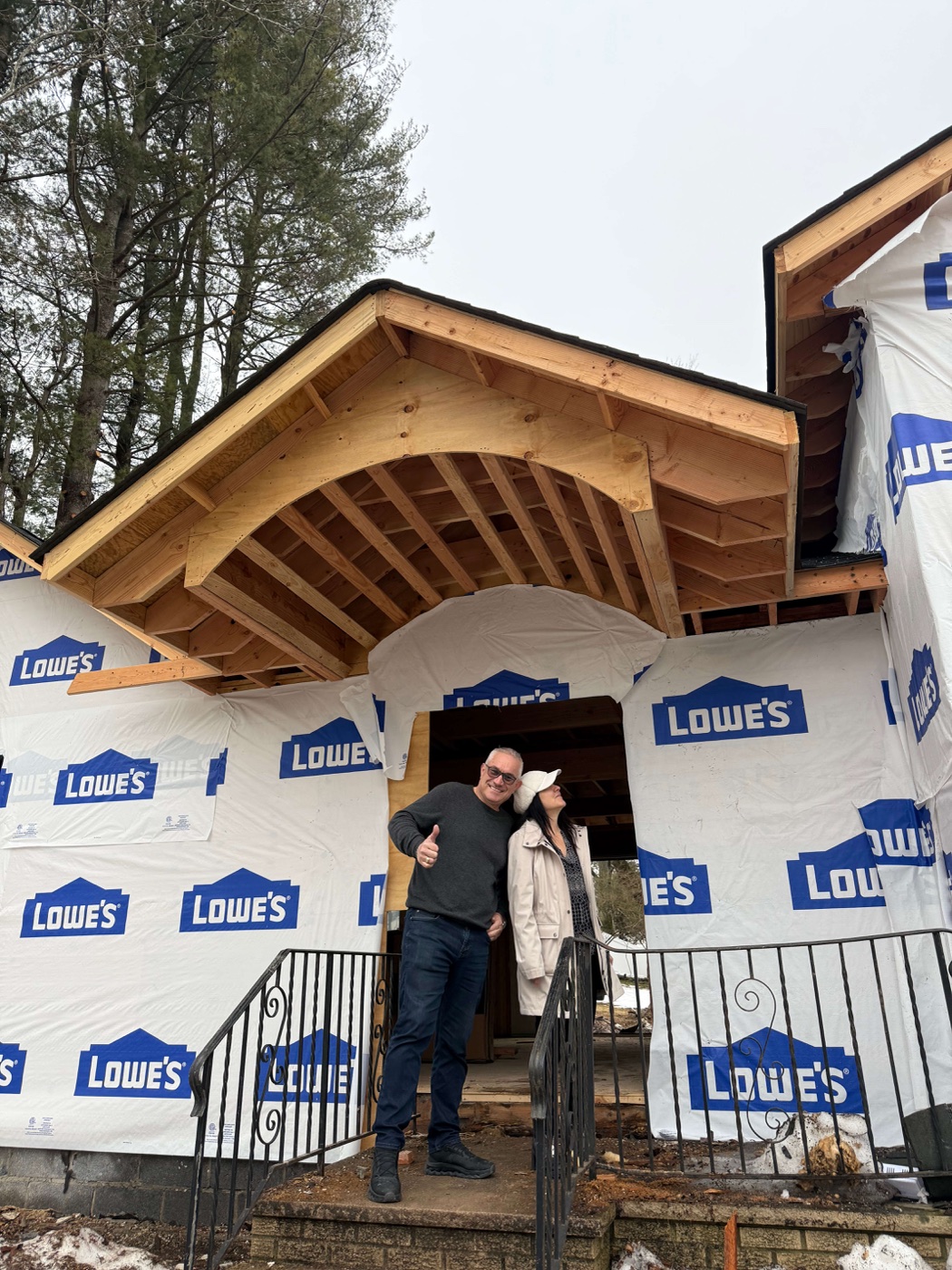 Dragan and Kosa Dinic, founders of Dadak LLC, standing in front of a custom home they built in Bergen County NJ